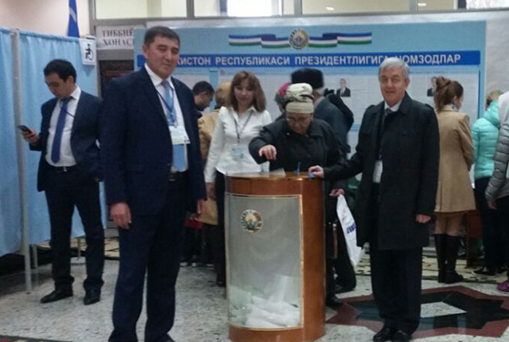 Prof. Yakubov observs one of the ballot boxes in the presidential elections in Uzbekistan