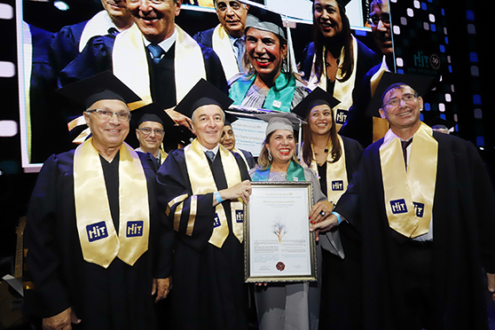 Mrs. Orna Pesach receiving an Honorary Degree on behalf of IMPACT!